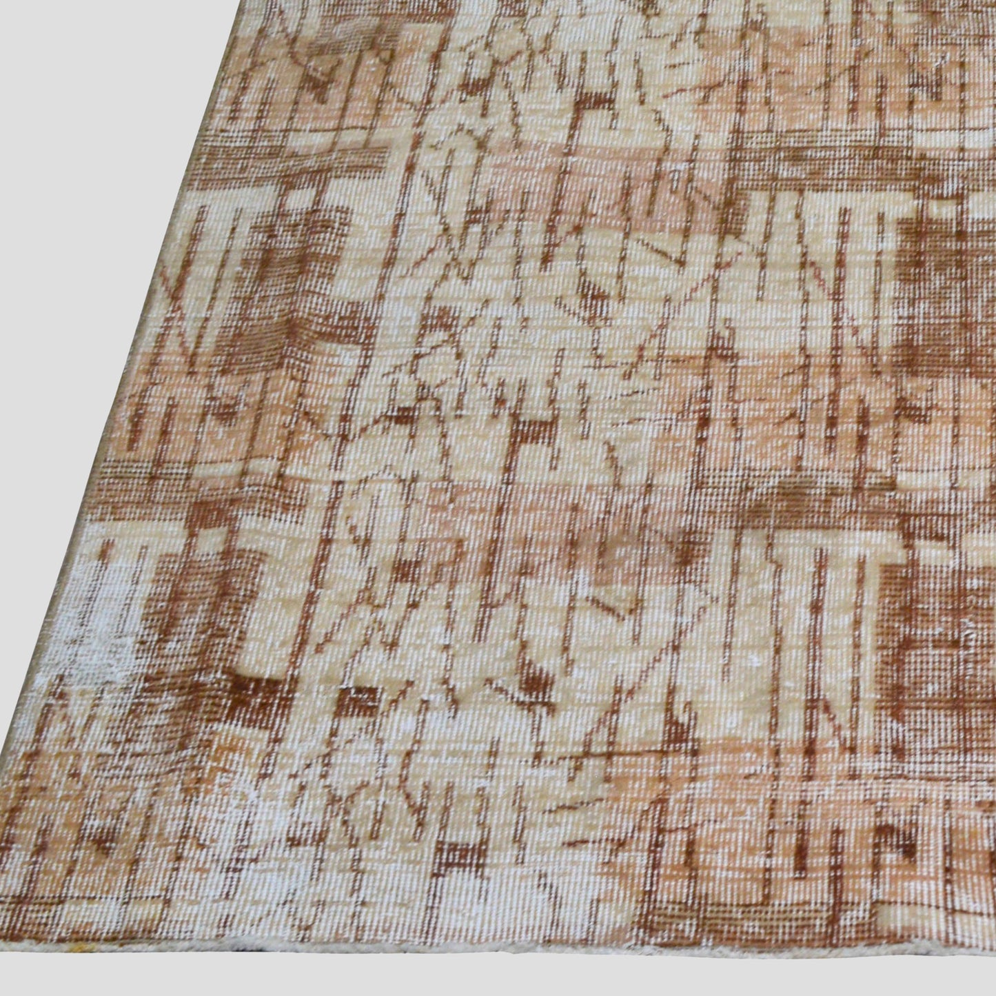 Vintage brown patterned Turkish wool rug, 4'9"x7', with natural fading and low pile.