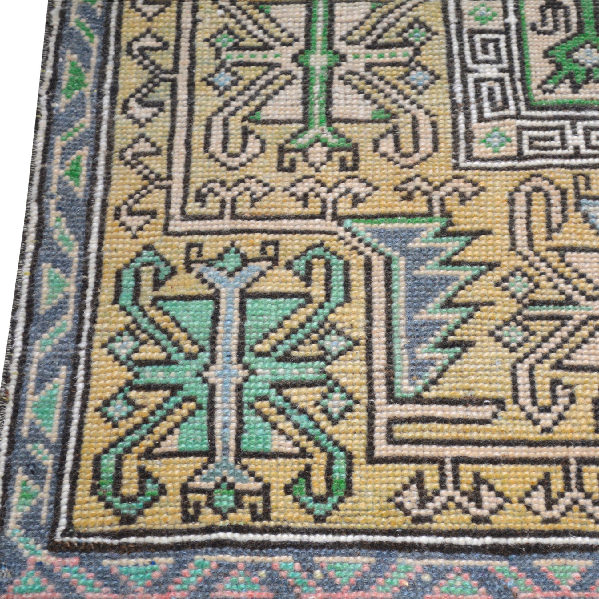Vintage cream, green, blue Turkish wool rug, 4'7"x9', with intricate geometric pattern and blue border.