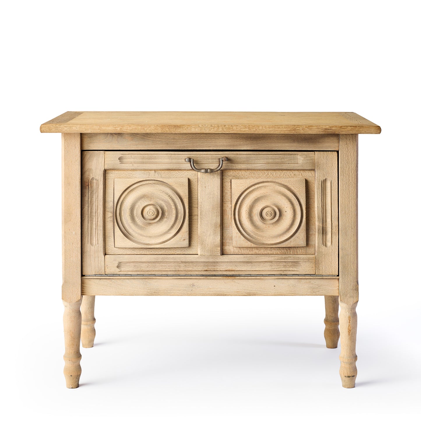 Bleached oak vintage bar console with carved circular door panels and a brass drop pull handle on turned legs.