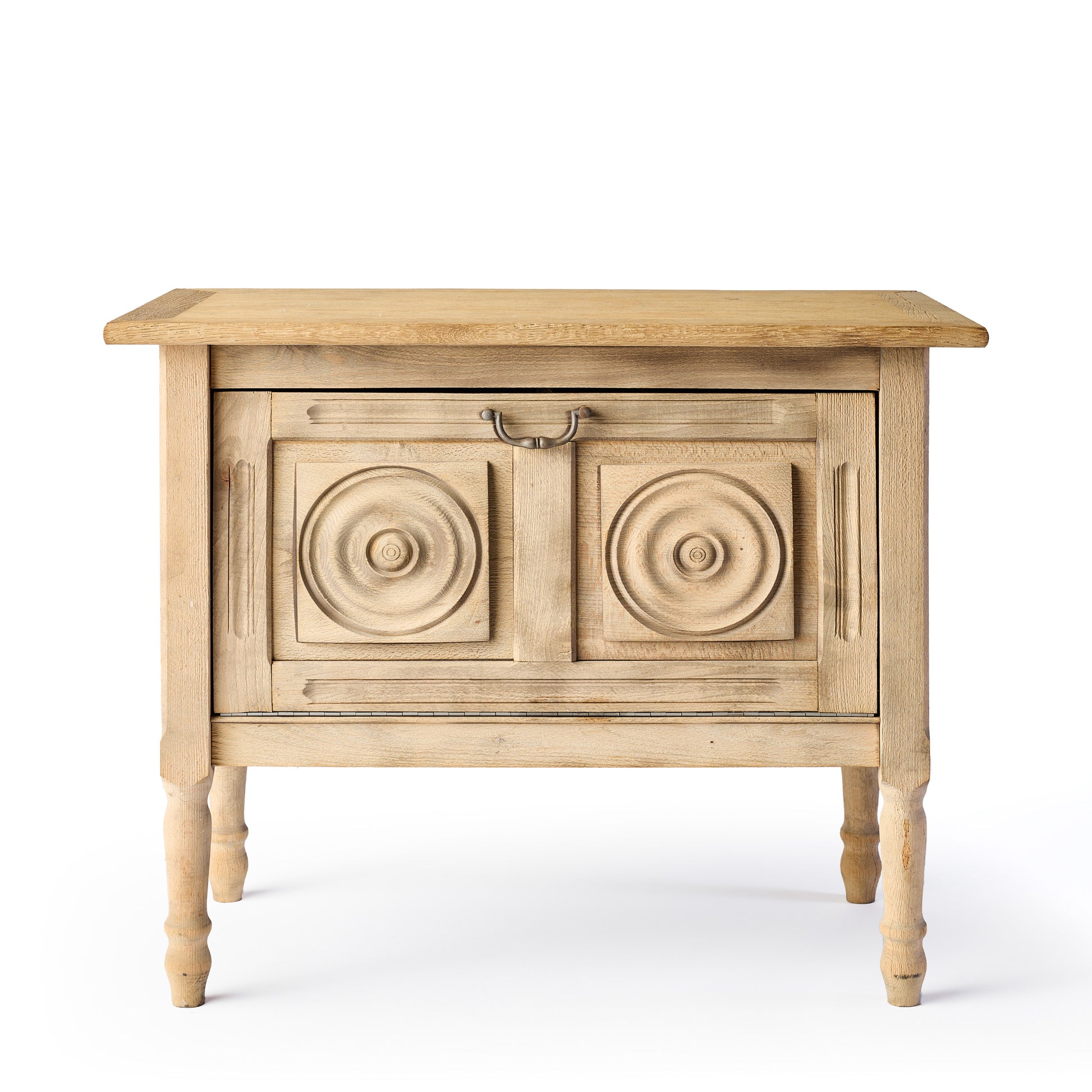 Bleached oak vintage bar console with carved circular door panels and a brass drop pull handle on turned legs.