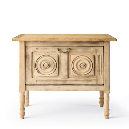 Bleached oak vintage bar console with carved circular door panels and a brass drop pull handle on turned legs.