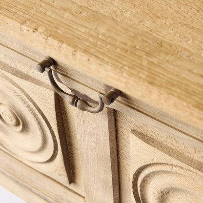 Bleached oak bar console with carved circular door patterns and a vintage brass drop pull handle.