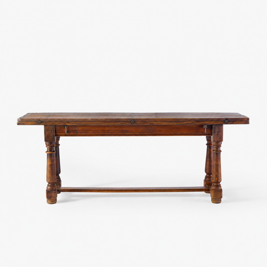 Vintage Jacobean-style folding refectory table in stained hardwood with iron butterfly hinges and turned legs.