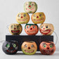 Set of nine vintage-style papier-mâché Halloween candy buckets with distressed, hand-painted jack-o'-lantern faces.