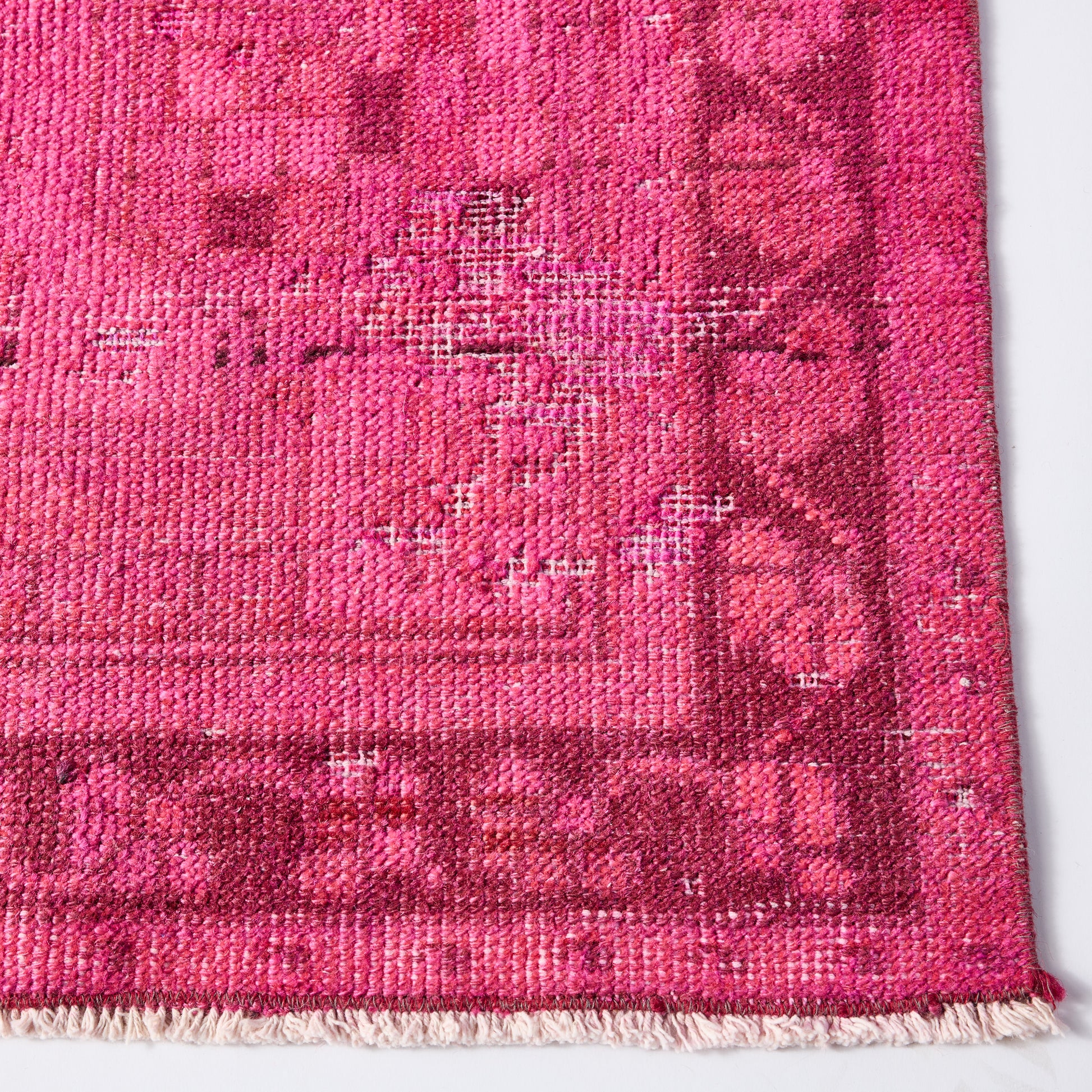 Vintage hot pink Turkish wool rug with a faded, low-pile patterned design and fringed edge, 4'3 x 8'4.