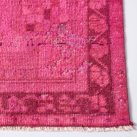 Vintage hot pink Turkish wool rug with a faded, low-pile patterned design and fringed edge, 4'3 x 8'4.