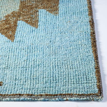 Handcrafted vintage wool runner rug in light blue and brown with a textured Aztec pattern and low-pile construction.