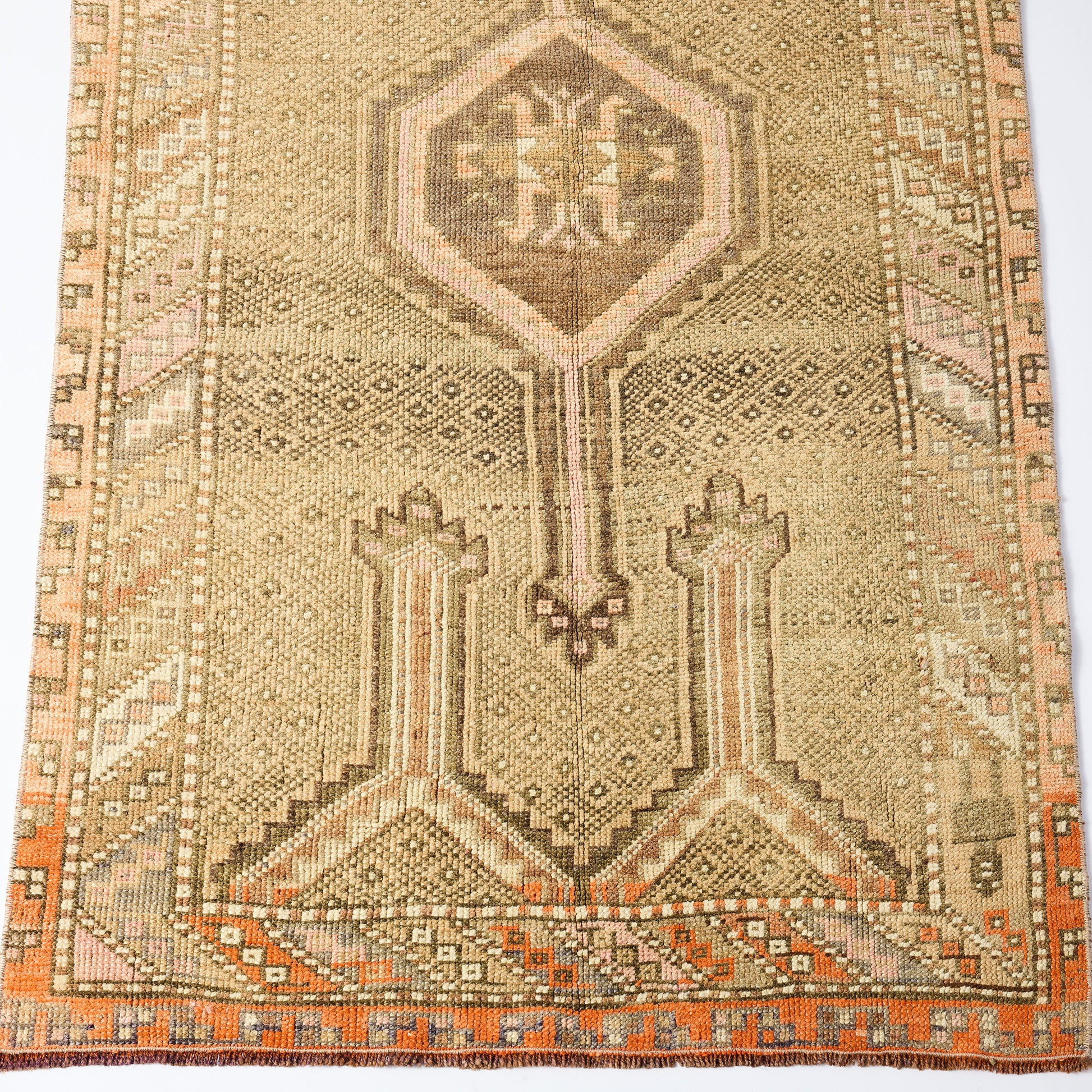 Vintage 3'2 x 5'6 wool runner rug with a faded beige and orange geometric pattern and traditional Turkish design.