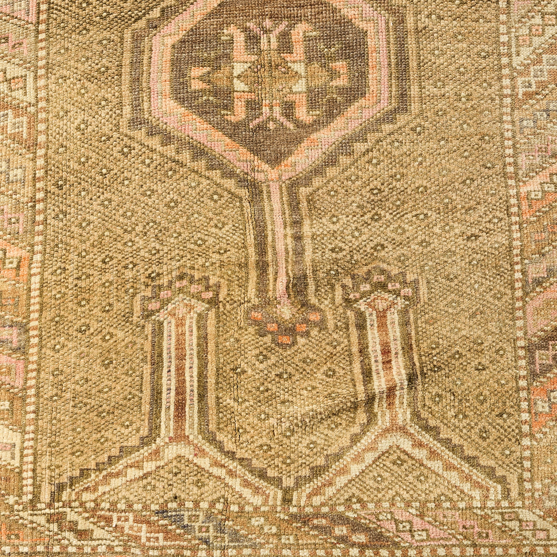 Handcrafted 3'2 x 5'6 wool runner rug with a faded vintage geometric pattern in tan, brown, and soft pink tones.