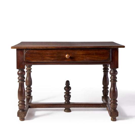 Vintage Louis XIII style dark wood desk with turned legs, a single central drawer, and a decorative cross-support.