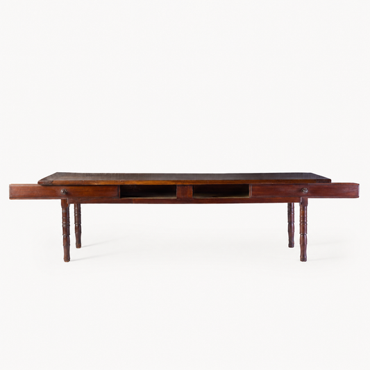 Vintage mahogany kitchen table with slender turned legs and two sliding storage drawers featuring detailed handles.