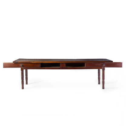 Vintage mahogany kitchen table with slender turned legs and two sliding storage drawers featuring detailed handles.