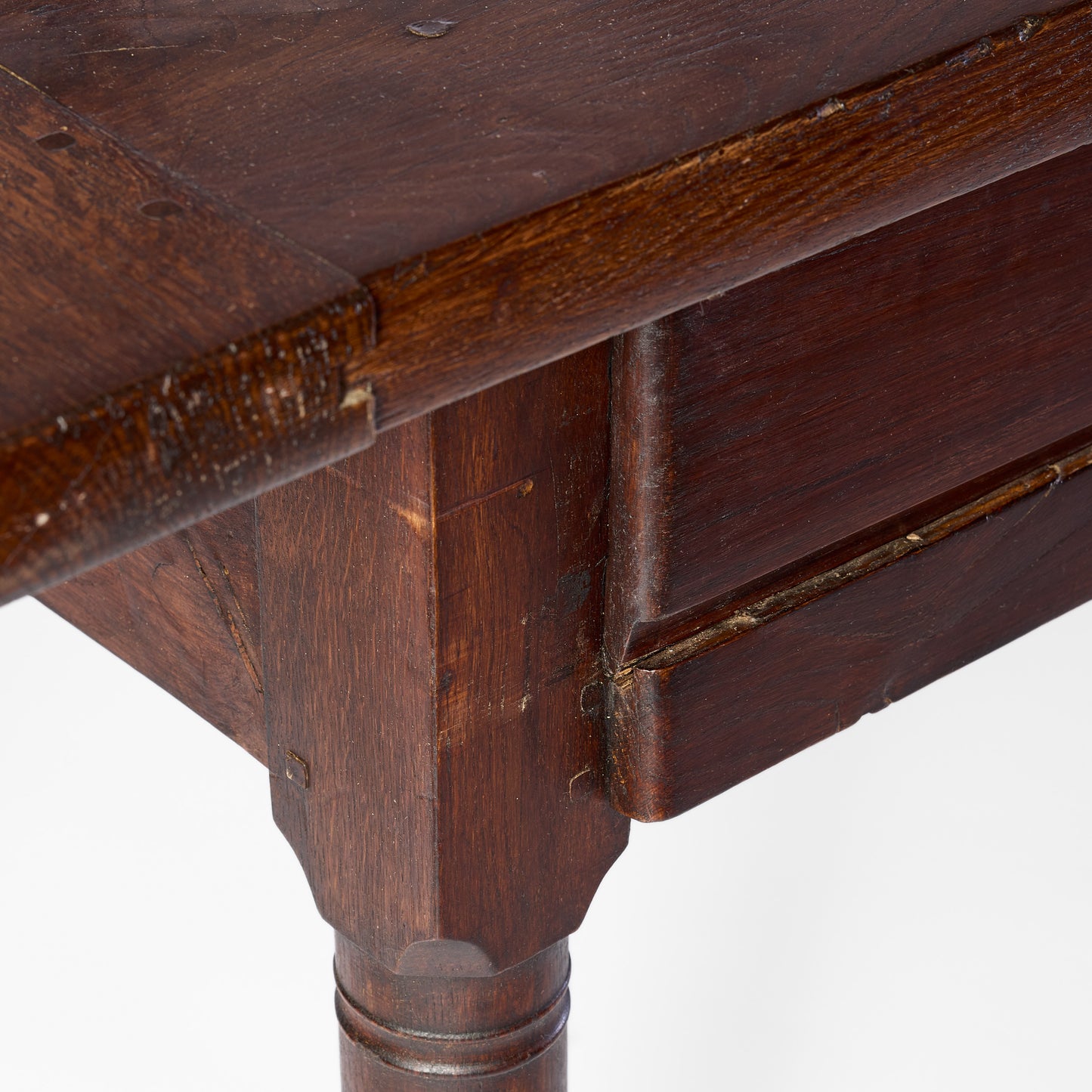 Vintage mahogany kitchen table with a dark wood finish, sliding storage compartment, and slender turned leg.