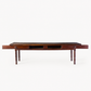 Vintage mahogany kitchen table with slender turned legs and two sliding storage drawers featuring detailed handles.