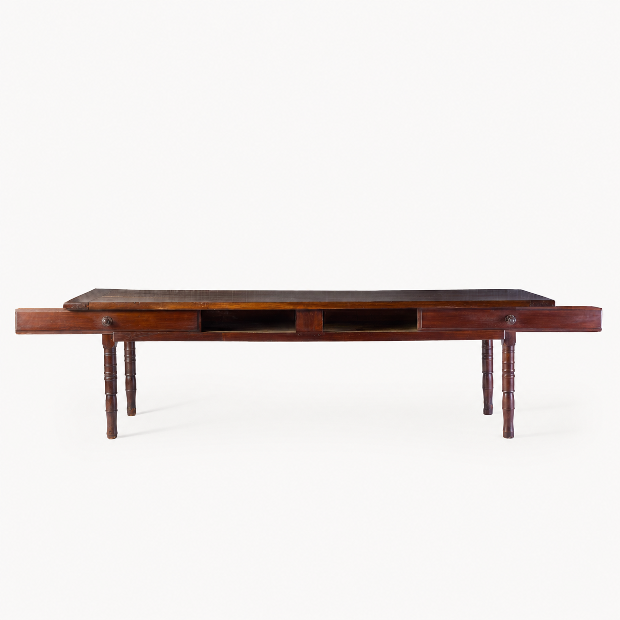 Vintage mahogany kitchen table with slender turned legs and two sliding storage drawers featuring detailed handles.