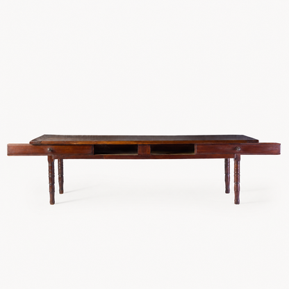 Vintage mahogany kitchen table with slender turned legs and two sliding storage drawers featuring detailed handles.