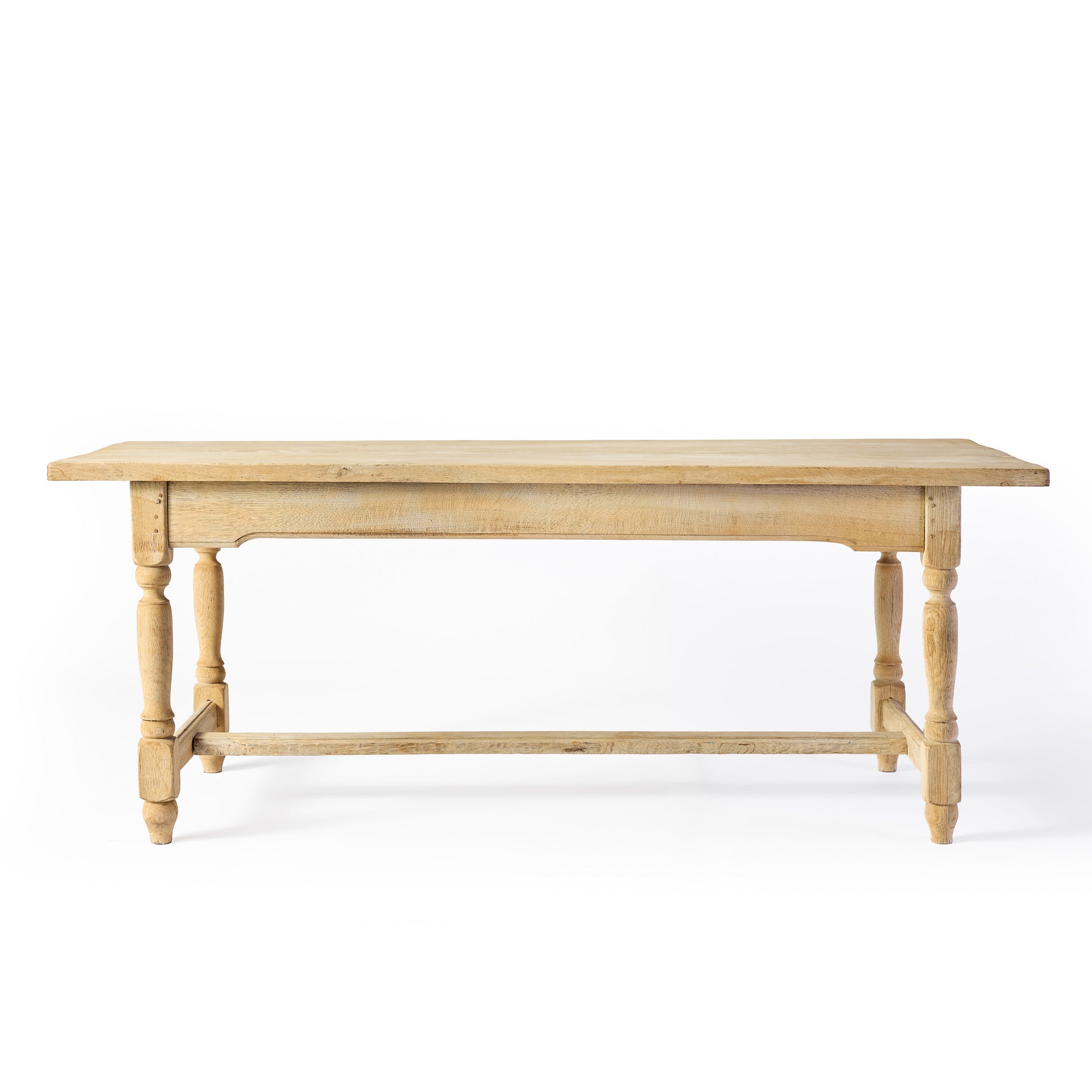 Vintage bleached oak dining table with turned knobbed baluster legs and a sturdy cross-base support.