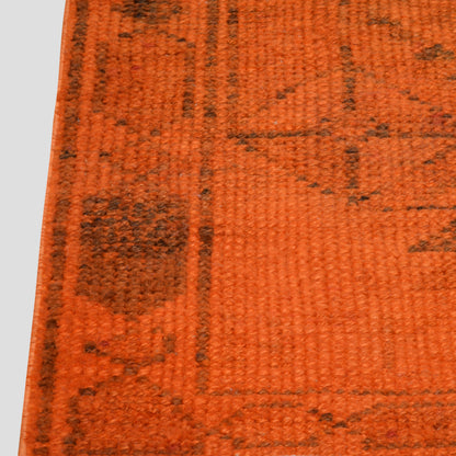 Vintage orange wool Turkish runner rug, 2'4" x 11', with faded black geometric pattern.