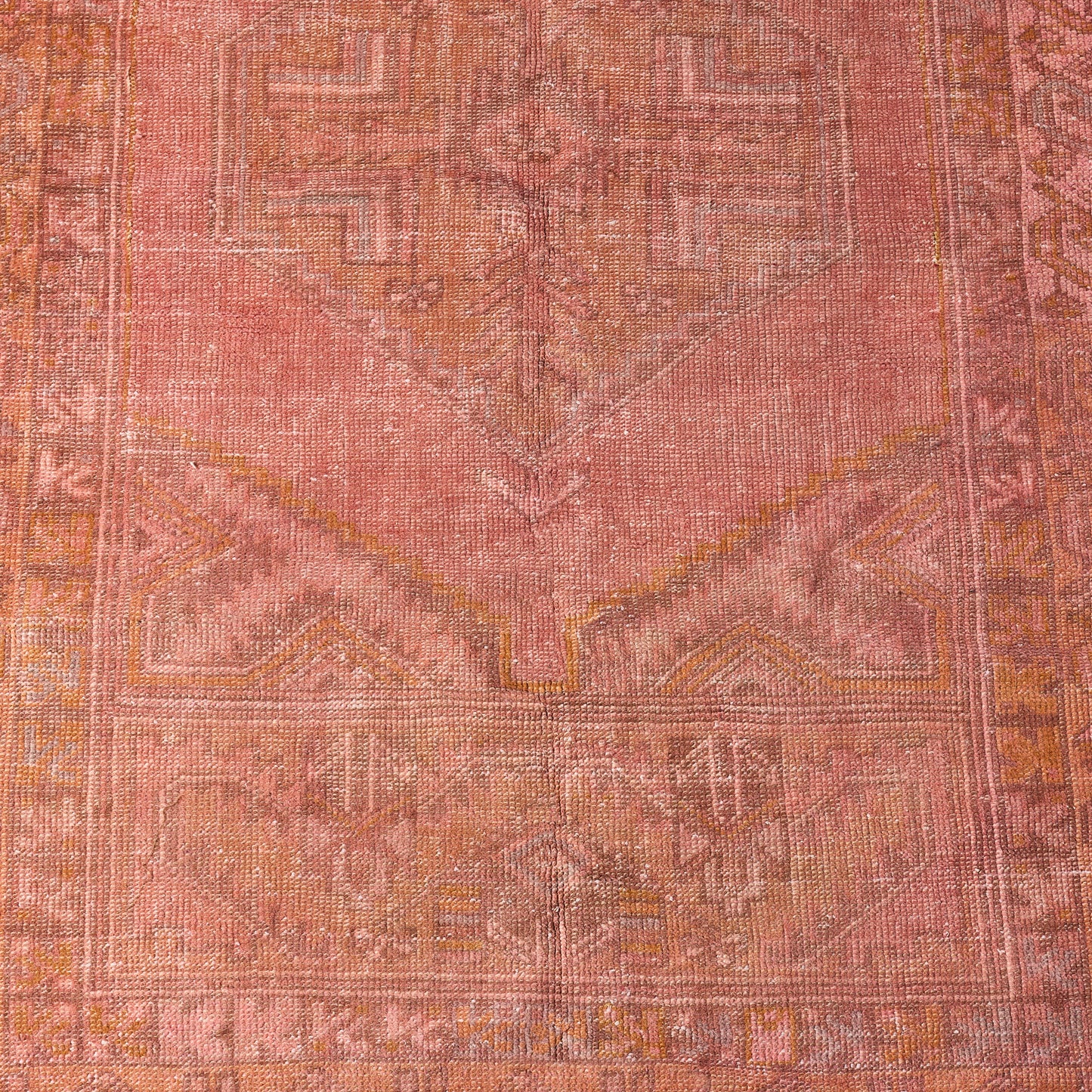Vintage pink wool rug with faded traditional patterns, handcrafted low-pile design, 3'10 x 6'1.