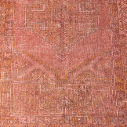 Vintage pink wool rug with faded traditional patterns, handcrafted low-pile design, 3'10 x 6'1.