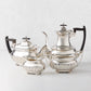 Vintage silverplate 4-piece tea set with ball feet, including teapot, coffee pot, creamer, and sugar bowl.