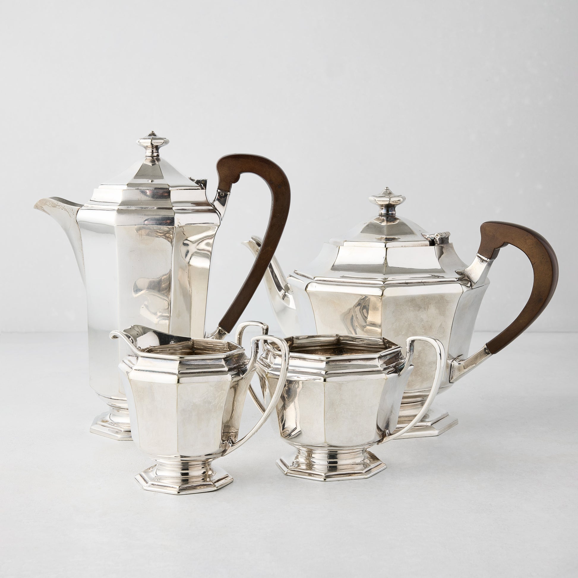 Vintage silverplate Audrey 4-piece tea set with wood handles, including teapot, coffee pot, sugar, and creamer.