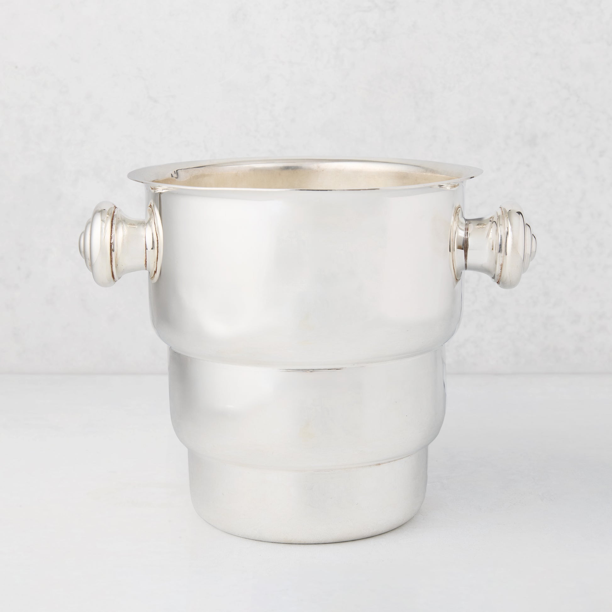 Vintage silverplate Behr champagne bucket with decorative handles.