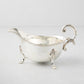Vintage silverplate Driscoll gravy boat with ornate handle and feet.