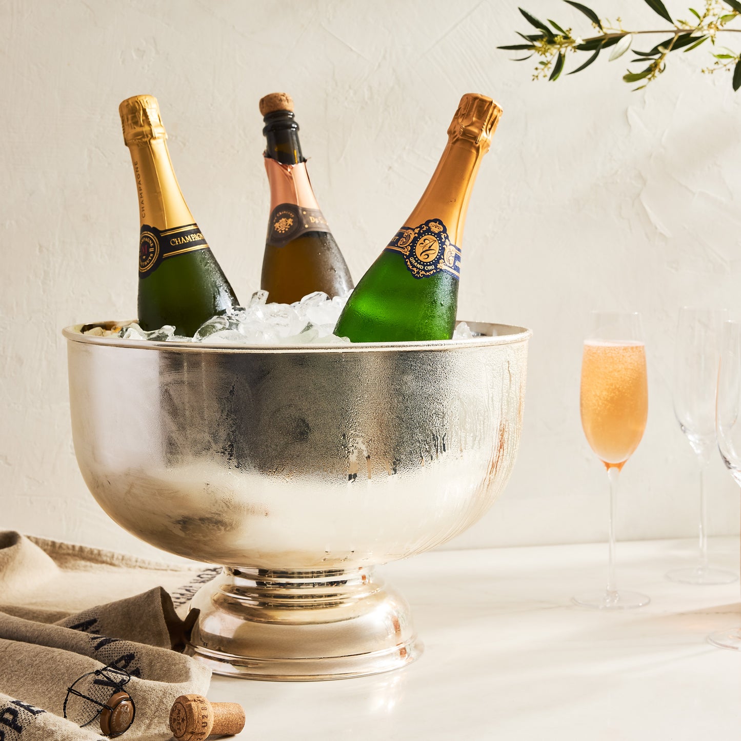 Vintage silverplate footed punch bowl, 14", holding three champagne bottles on ice.