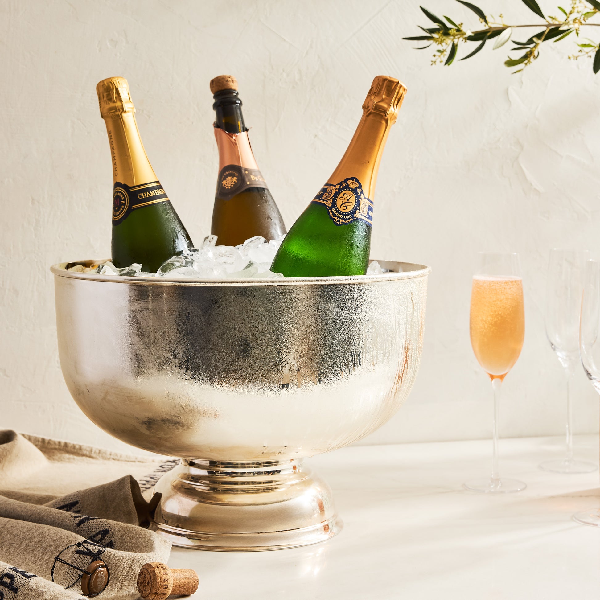 Vintage silverplate footed punch bowl, 14", holding three champagne bottles on ice.