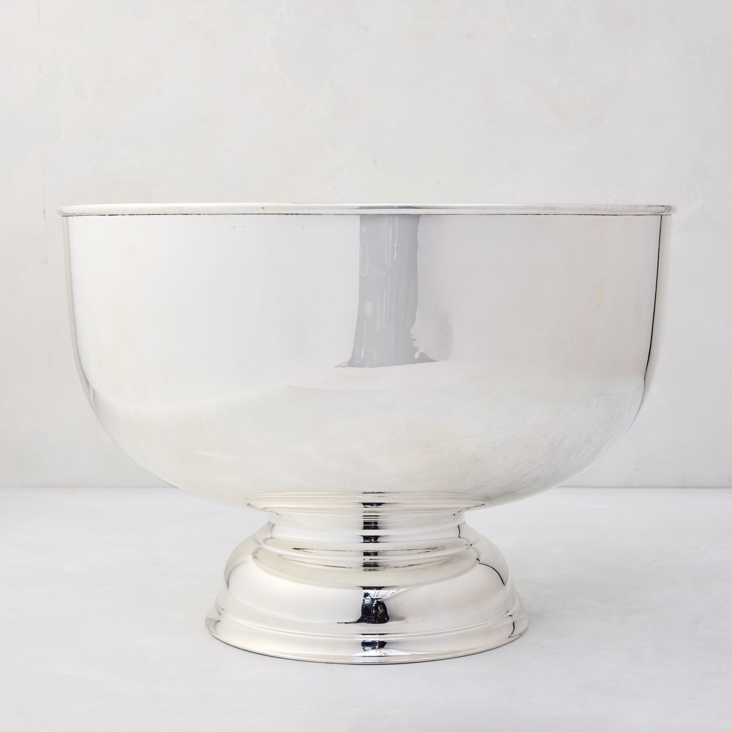 Vintage silverplate footed punch bowl, 14", with a reflective finish and elegant Revere-style design.