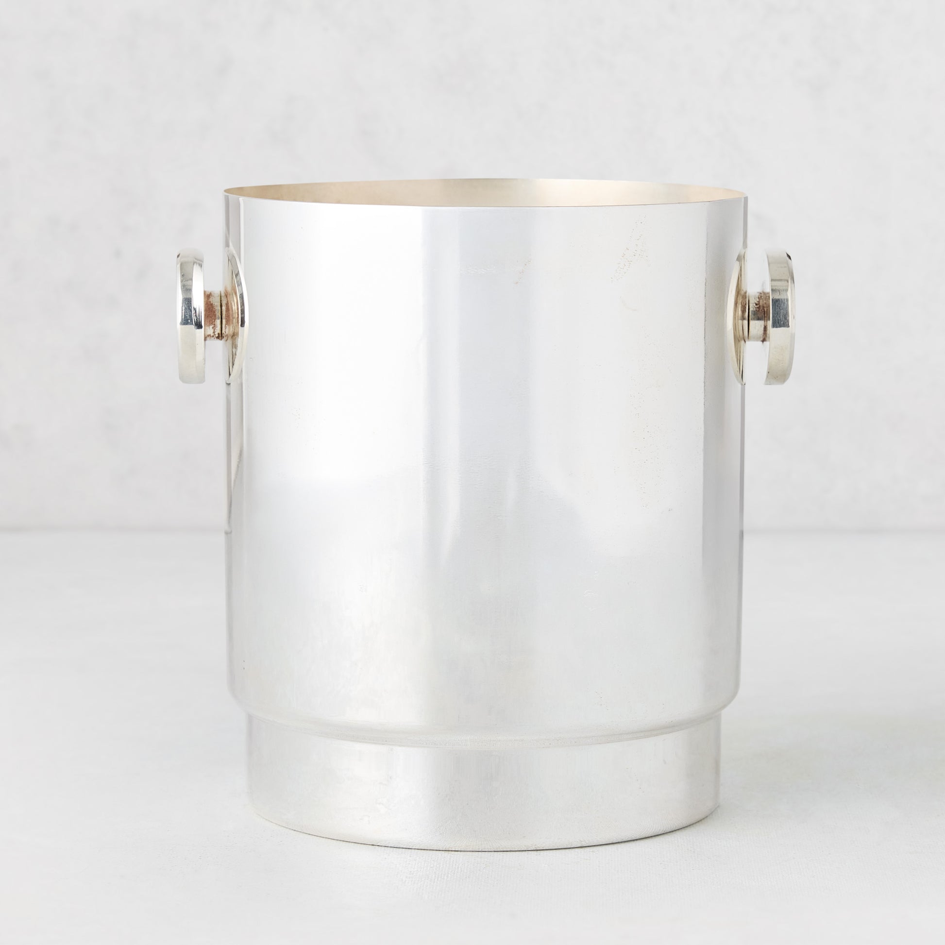 Vintage silverplate Gabby ice bucket with round handles, shiny finish.