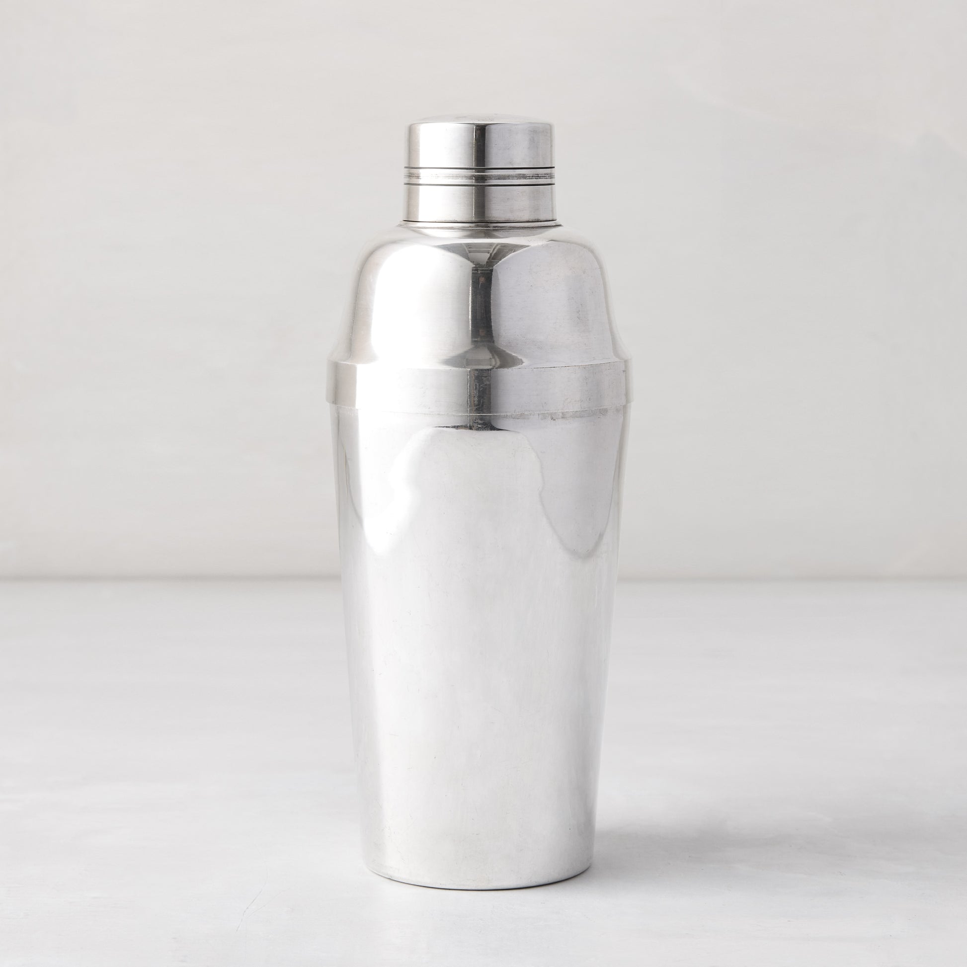 Vintage silverplate Iris cocktail shaker, polished, with a three-piece design.