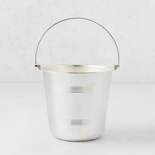 Vintage silverplate ice bucket with a tapered cylindrical body, horizontal ribbed detailing, and a thin wire handle.
