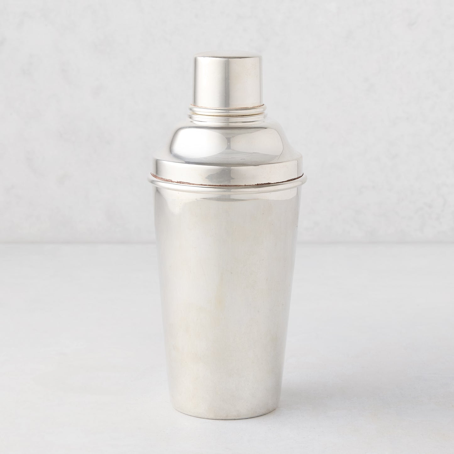 Vintage silverplate cocktail shaker with ivy design.