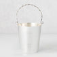 Vintage silverplate James ice bucket with a twisted handle and horizontal bands.