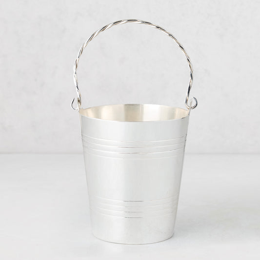 Vintage silverplate James ice bucket with a twisted handle and horizontal bands.