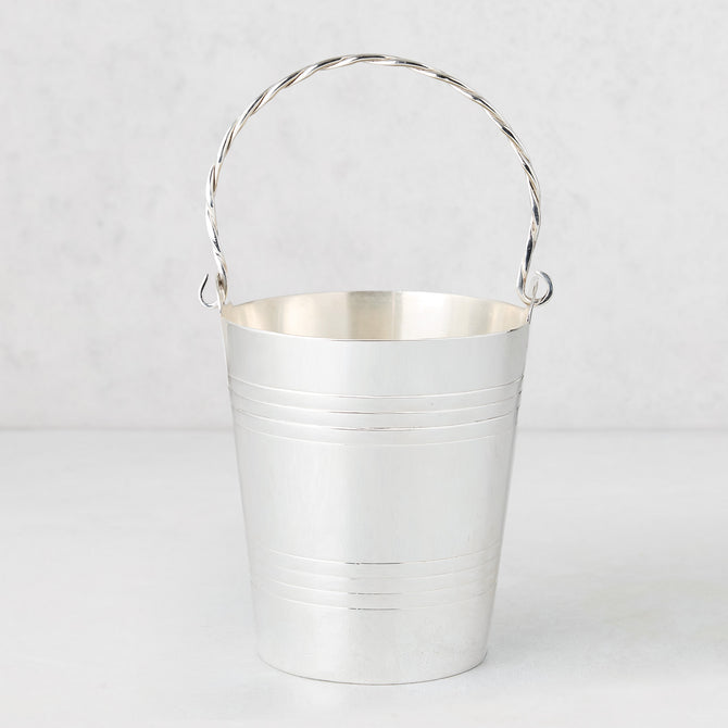 Vintage silverplate James ice bucket with a twisted handle and horizontal bands.