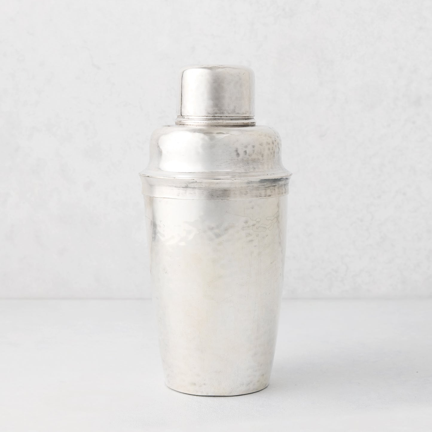 Vintage silverplate Leonor cocktail shaker with hammered texture.