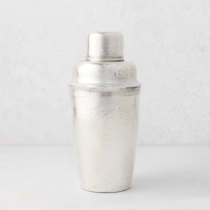Vintage silverplate Leonor cocktail shaker with hammered texture.