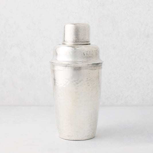 Vintage silverplate Leonor cocktail shaker with hammered texture.