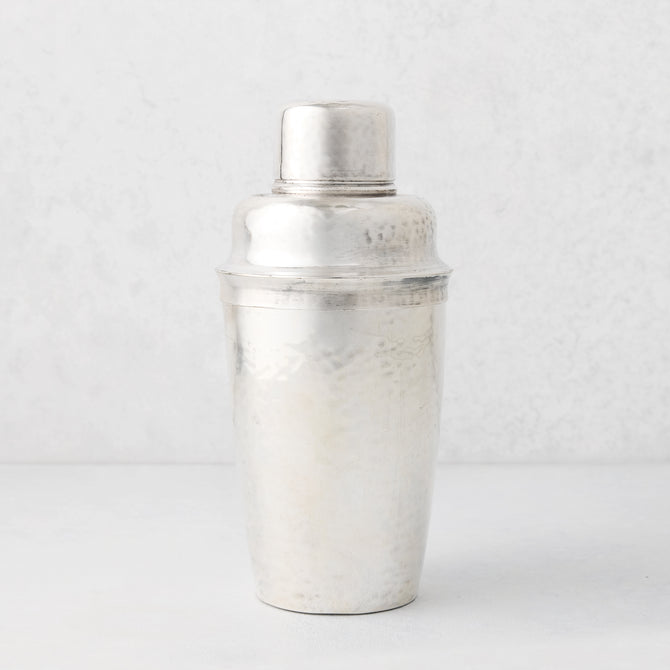 Vintage silverplate Leonor cocktail shaker with hammered texture.