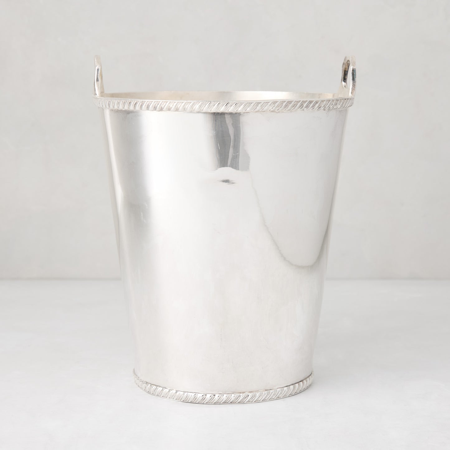 Vintage silverplate Margot champagne bucket with side handles and rope-style trim detail.