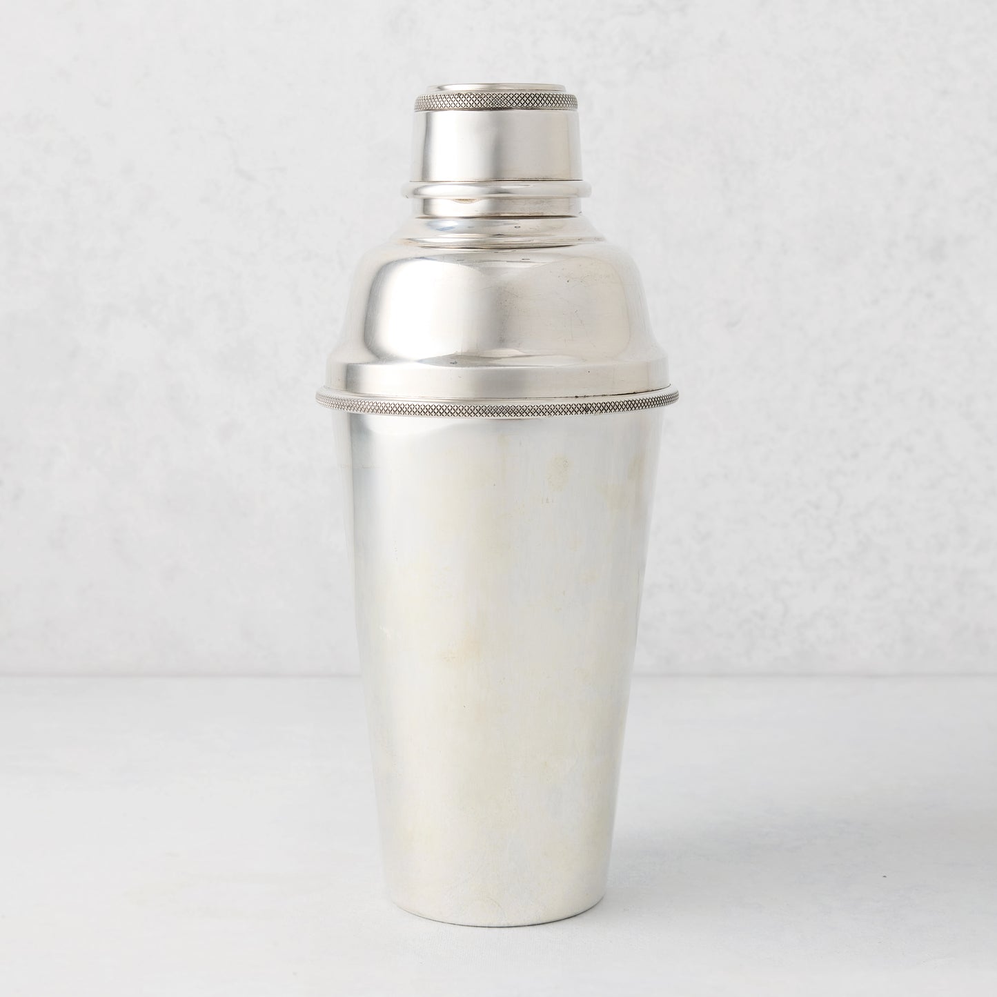 Vintage silverplate Nola cocktail shaker with a textured band.