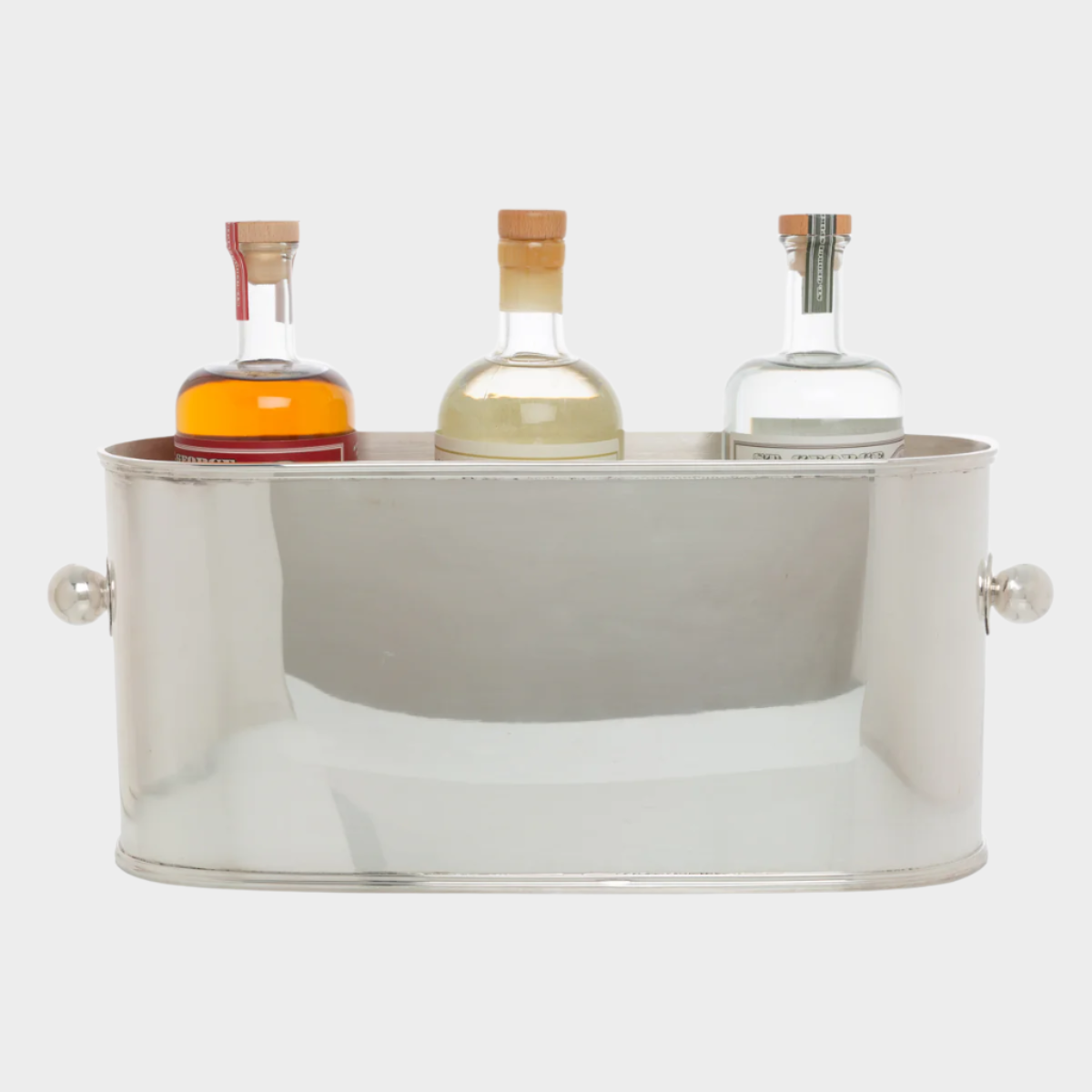 Vintage silverplate oval 4-bottle ice bucket with ball handles, holding three liquor bottles.