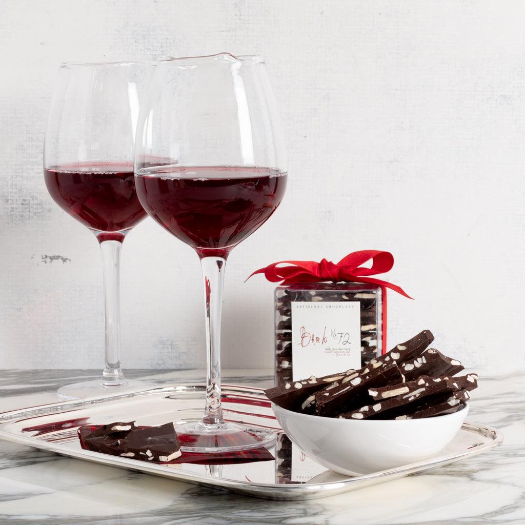 Vintage silverplate rectangular hotel serving tray with two wine glasses and chocolate.