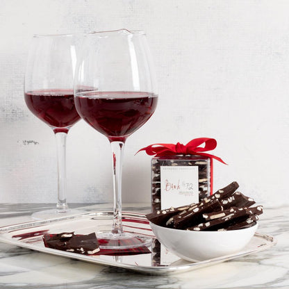 Vintage silverplate rectangular hotel serving tray with two wine glasses and chocolate.