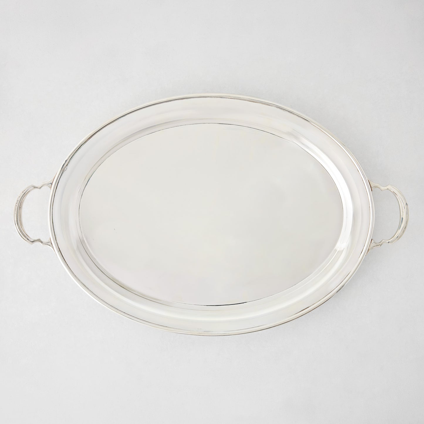 Vintage silverplate Sofia oval tray, 23 inches, with handles and a shiny finish.