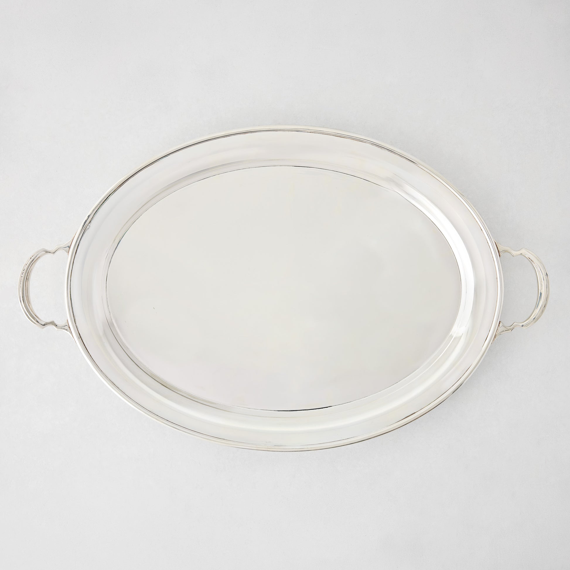 Vintage silverplate Sofia oval tray, 23 inches, with handles and a shiny finish.