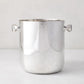 Vintage silverplate champagne bucket with two side handles and a polished finish on a light background.